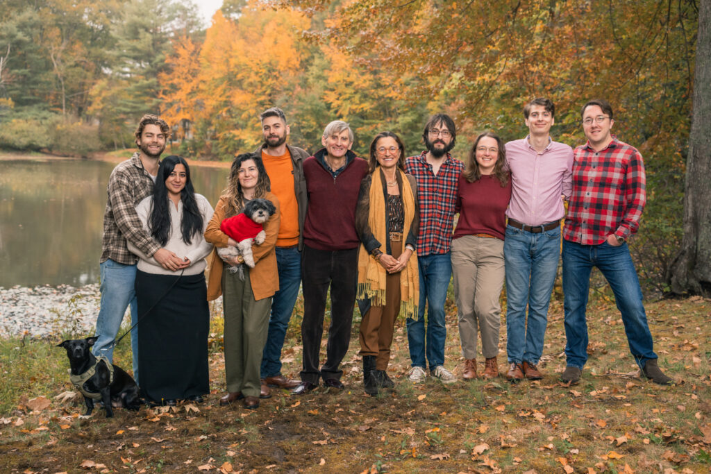 Extended family photo taken in Lincoln, MA with fall foliage in background