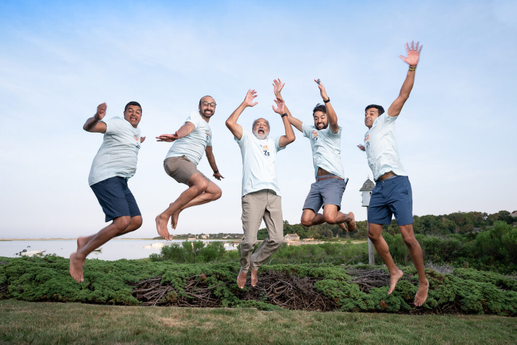 A joyful group of men jumping during a summer photo session in Boston by Boston photographer Corey Flint.