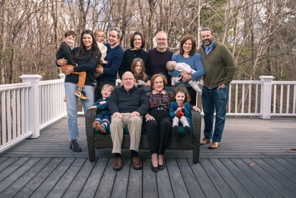 Large family gathered for an extended family photo on their porch in Lincoln, MA