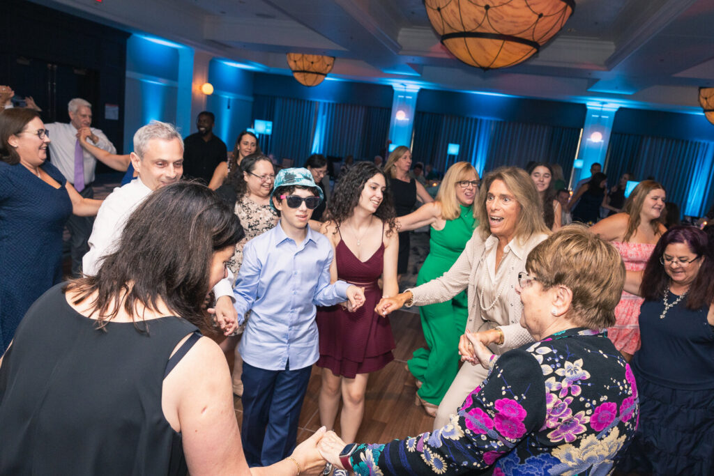 Friends hugging and laughing at bar mitzvah party