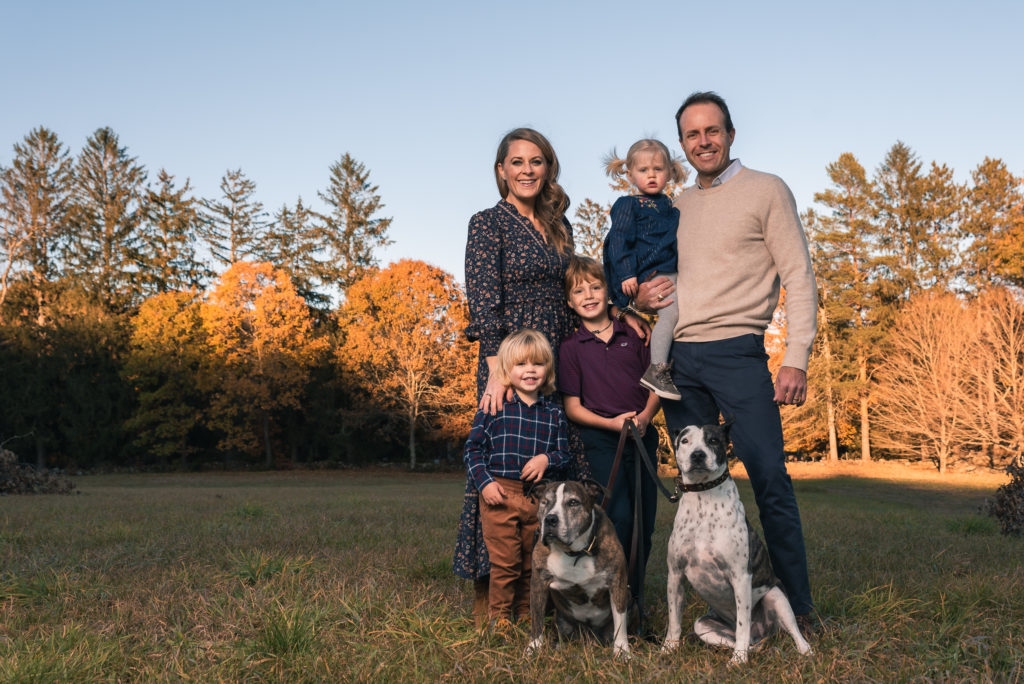 Family with dogs wearing earth tones for family photo session
