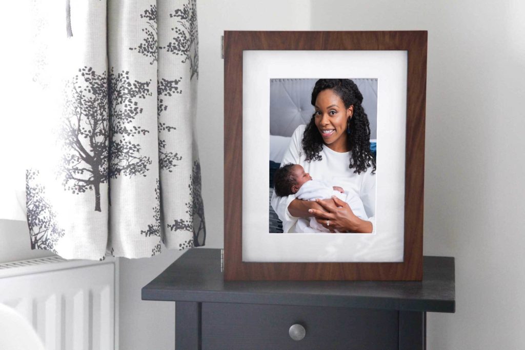 Shows printed family photos on a nightstand. 