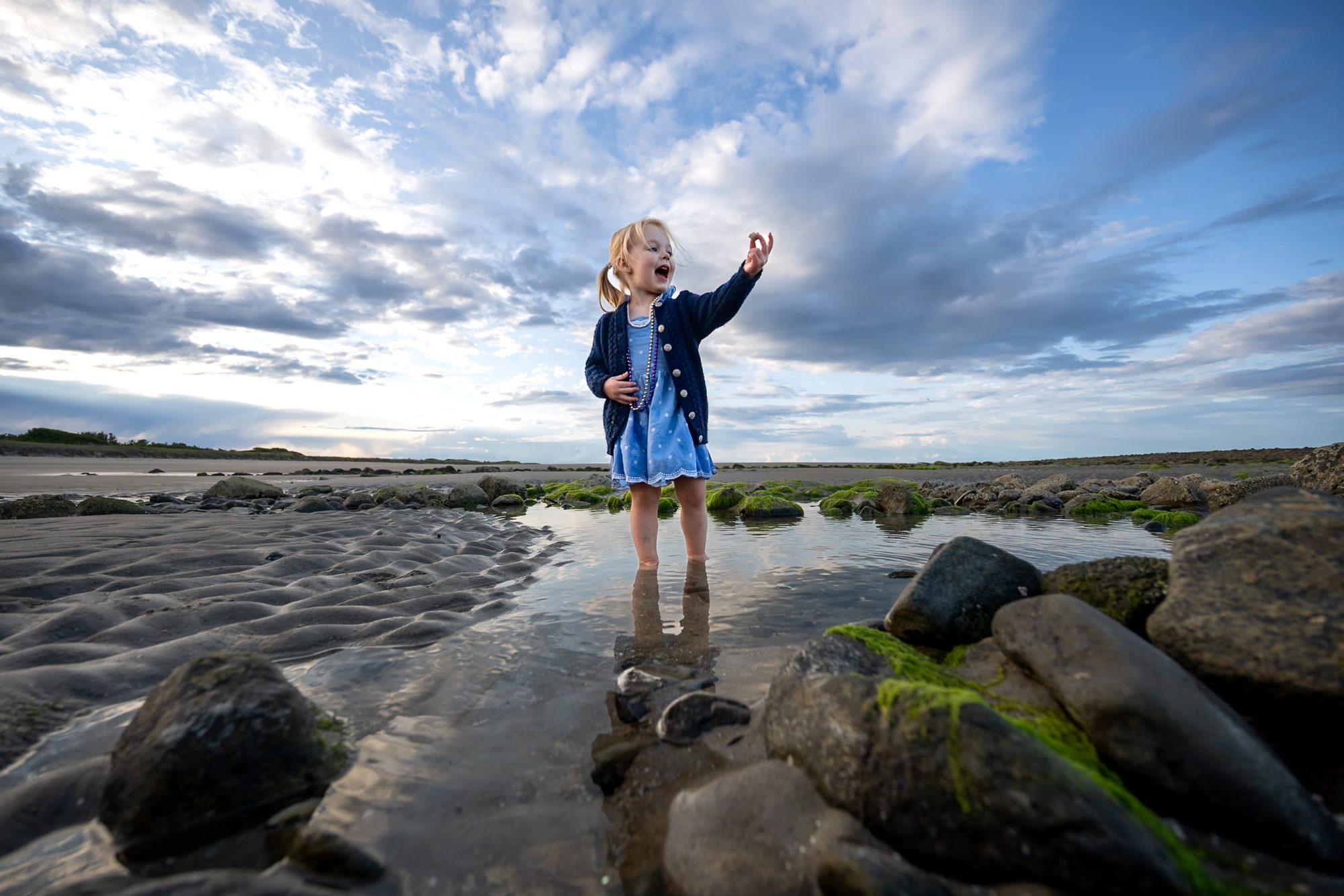A girl on a day trip from Boston exploring a beach on plum island.